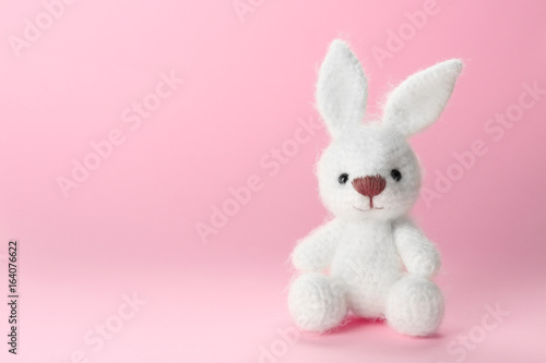 Cute handmade bunny toy on color background  closeup