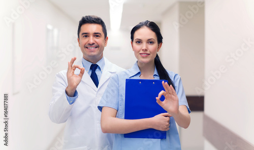 doctor and nurse showing ok sign at hospital