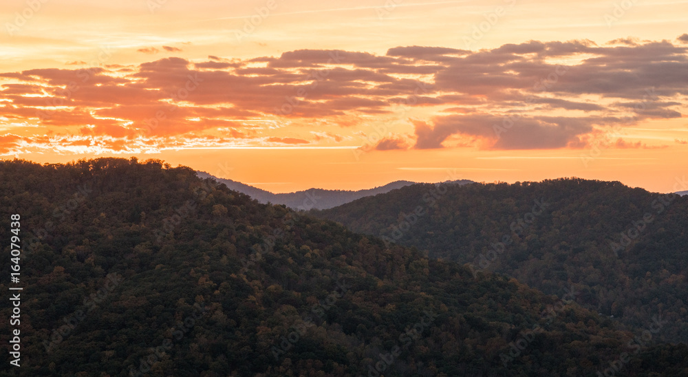 orange moorig sky at daybreak over the rolling hills and mountains of the North Carolina Appalachians in the fall