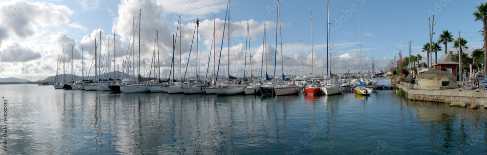 Sailboats berthed on Alghero’s harbor