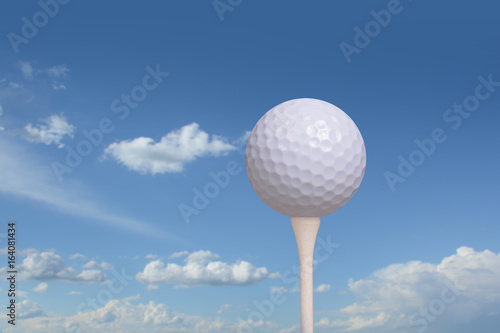 golf ball on golf tee blue sky background