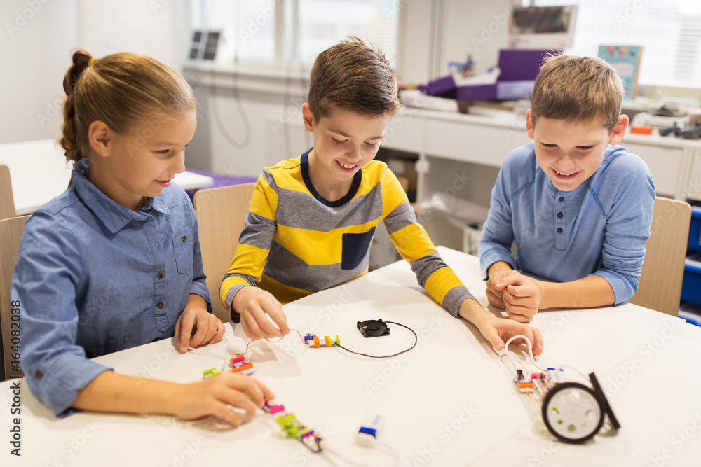 happy children building robots at robotics school happy children building robots at robotics school