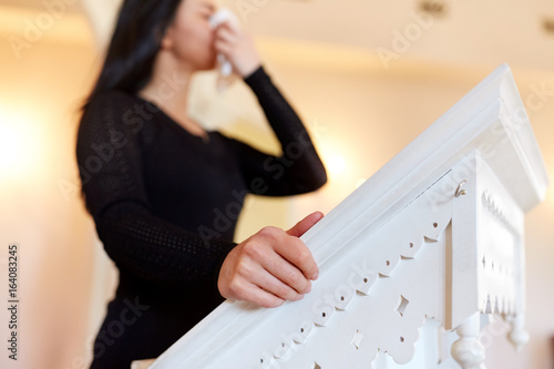 woman near tribune crying at funeral in church