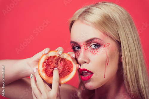 girl with creative fashionable makeup hold grapefruit, vitamin