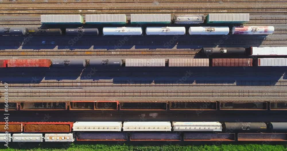 Looking straight down on industrial railroad rail train yard, many trains, tracks. Dynamic aerial view. Looking straight down on industrial railroad rail train yard, many trains, tracks. Dynamic aerial view.