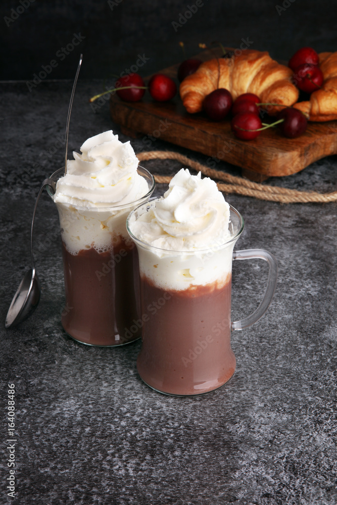 Iced coffee with whipped cream in tall glass and fresh croissant Iced coffee with whipped cream in tall glass and fresh croissant