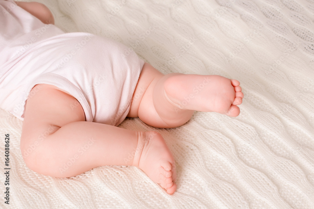 The kid crawls on the bed The kid crawls on the bed