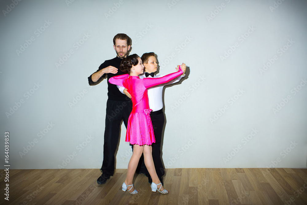 The young boy and girl posing at dance studio The young boy and girl posing at dance studio