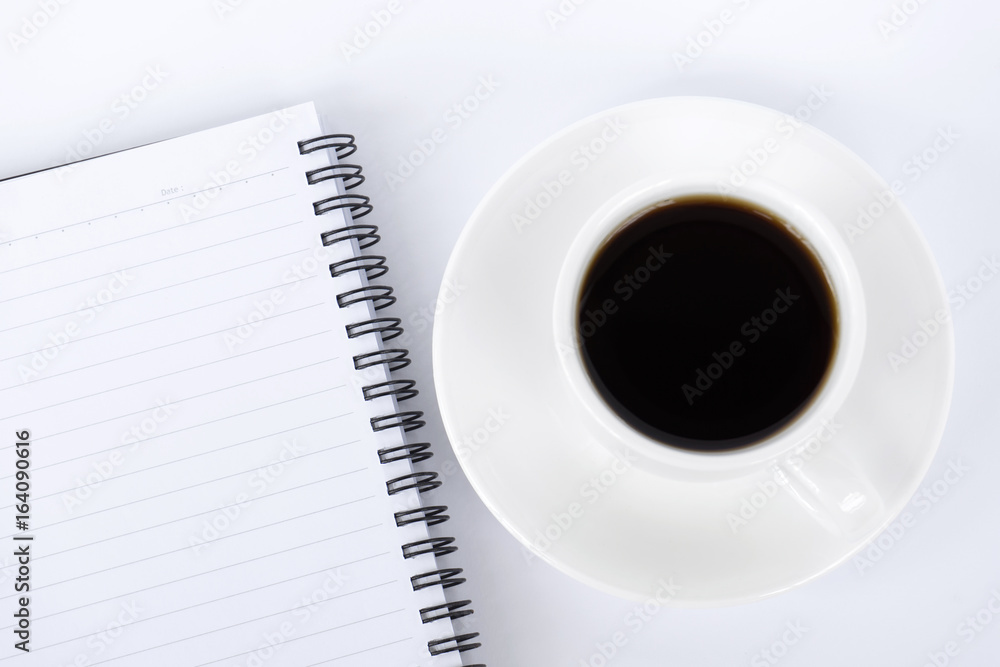 To view of coffee and notepad on white background To view of coffee and notepad on white background