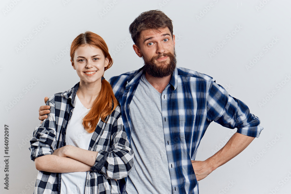 Young guy with beard and beautiful woman on white isolated background, repair, housework Young guy with beard and beautiful woman on white isolated background, repair, housework