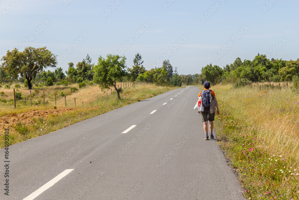 Girl hiking in road with cork trees in Vale Seco, Santiago do Cacem