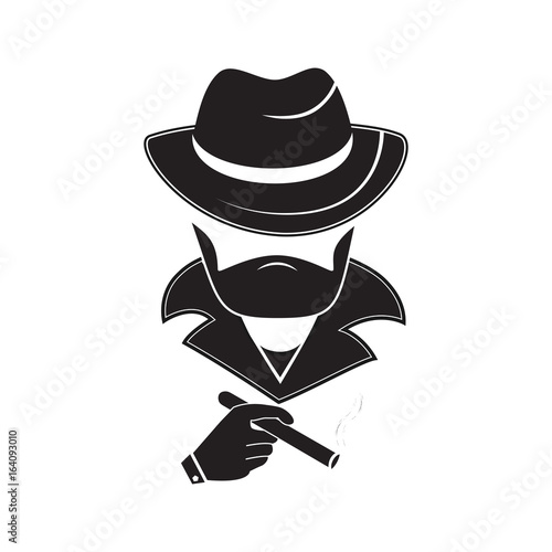 A stranger in a hat holds a smoking cigarette in his hand. Mafia style.