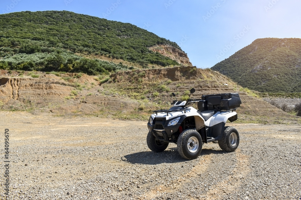 ATV offroad on mountain and sky background. ATV offroad on mountain and sky background.