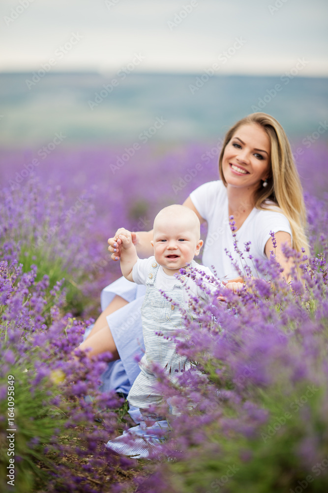 Happy mother and her little baby boy having fun in a lavender field Happy mother and her little baby boy having fun in a lavender field