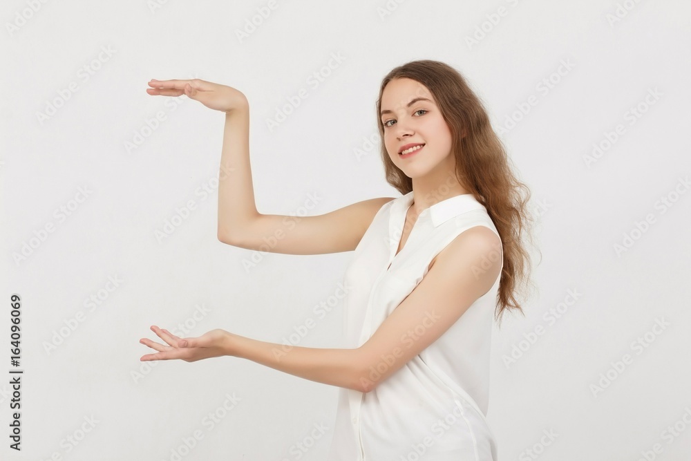 Portrait of young woman pointing hands finger at corner with copyspace isolated on a white background.Цoman with finger point up Portrait of young woman pointing hands finger at corner with copyspace isolated on a white background.Цoman with finger point up