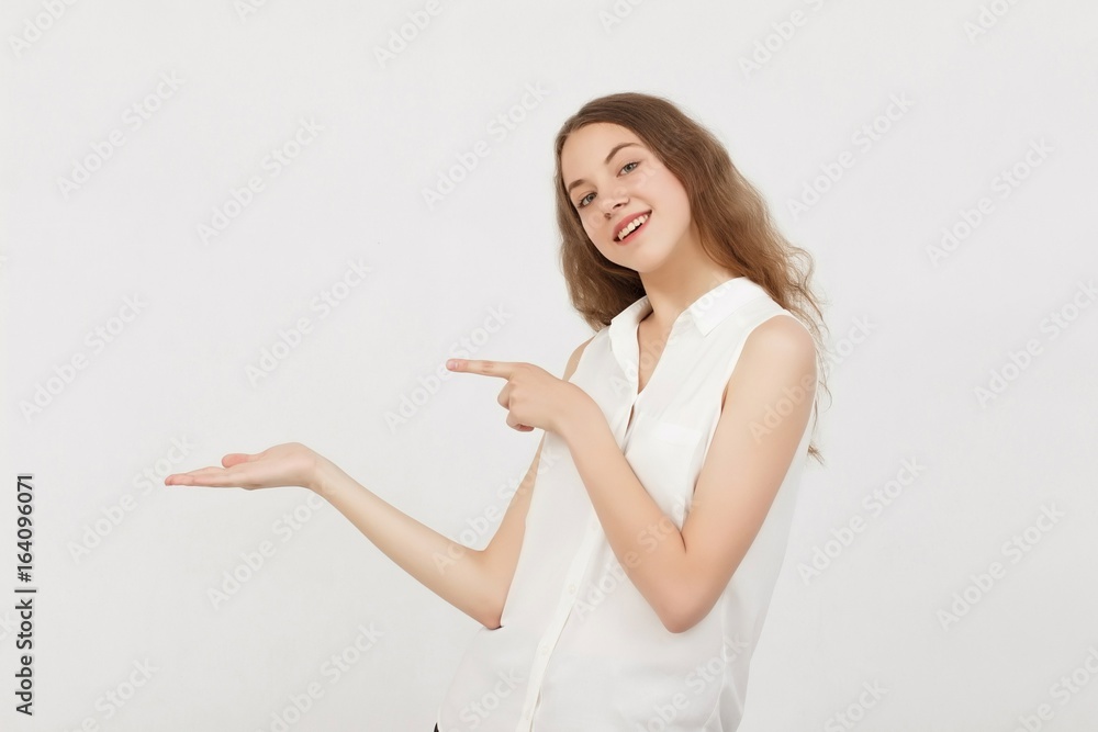 Portrait of young woman pointing hands finger at corner with copyspace isolated on a white background.Цoman with finger point up Portrait of young woman pointing hands finger at corner with copyspace isolated on a white background.Цoman with finger point up