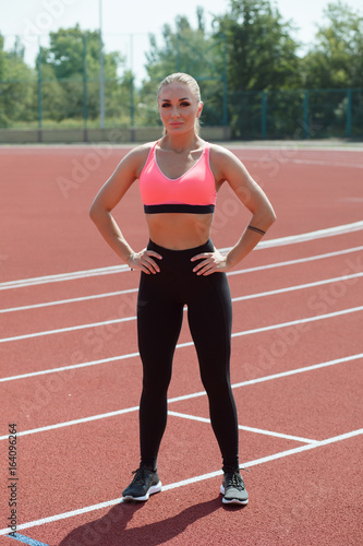 Portrait of sport woman athlete on stadium track