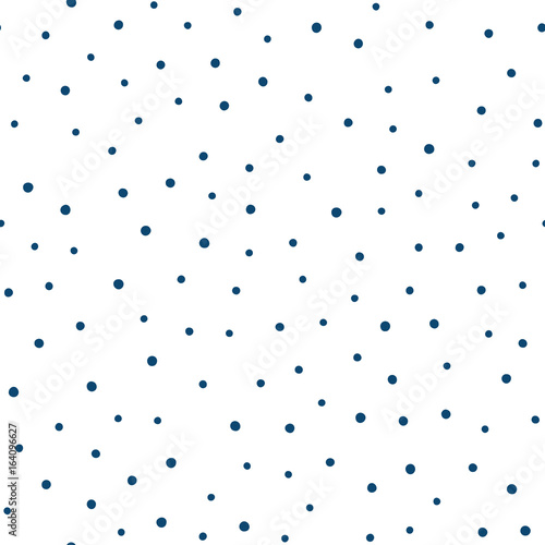 Seamless pattern with randomly scattered small round spots. Drawn by hand. Blue dots on a white background.