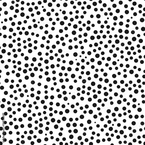 Chaotically scattered small round spots. Seamless pattern.