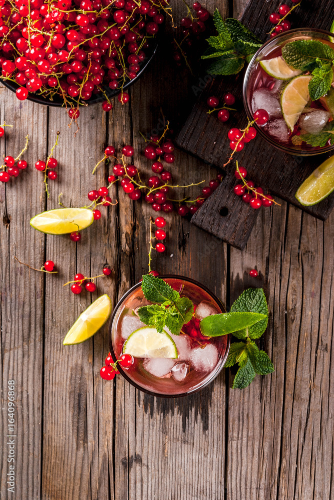 Ideas of summer drinks, dietary healthy cocktails. Mojito from lime, mint and red currant. On the old rustic wooden table, with the ingredients. Copy space top view Ideas of summer drinks, dietary healthy cocktails. Mojito from lime, mint and red currant. On the old rustic wooden table, with the ingredients. Copy space top view