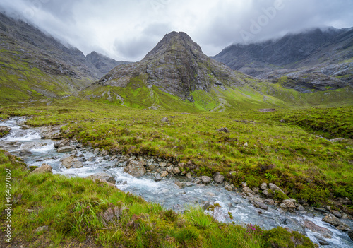 The famous Fairy Pools with the Black Cuillin Mountains in the background, Isle of Skye, Scotland. © e55evu