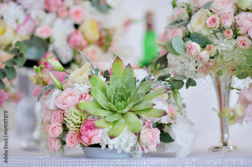 luxury wedding decorations with gentle rose and white tones, bouquet on a table close up