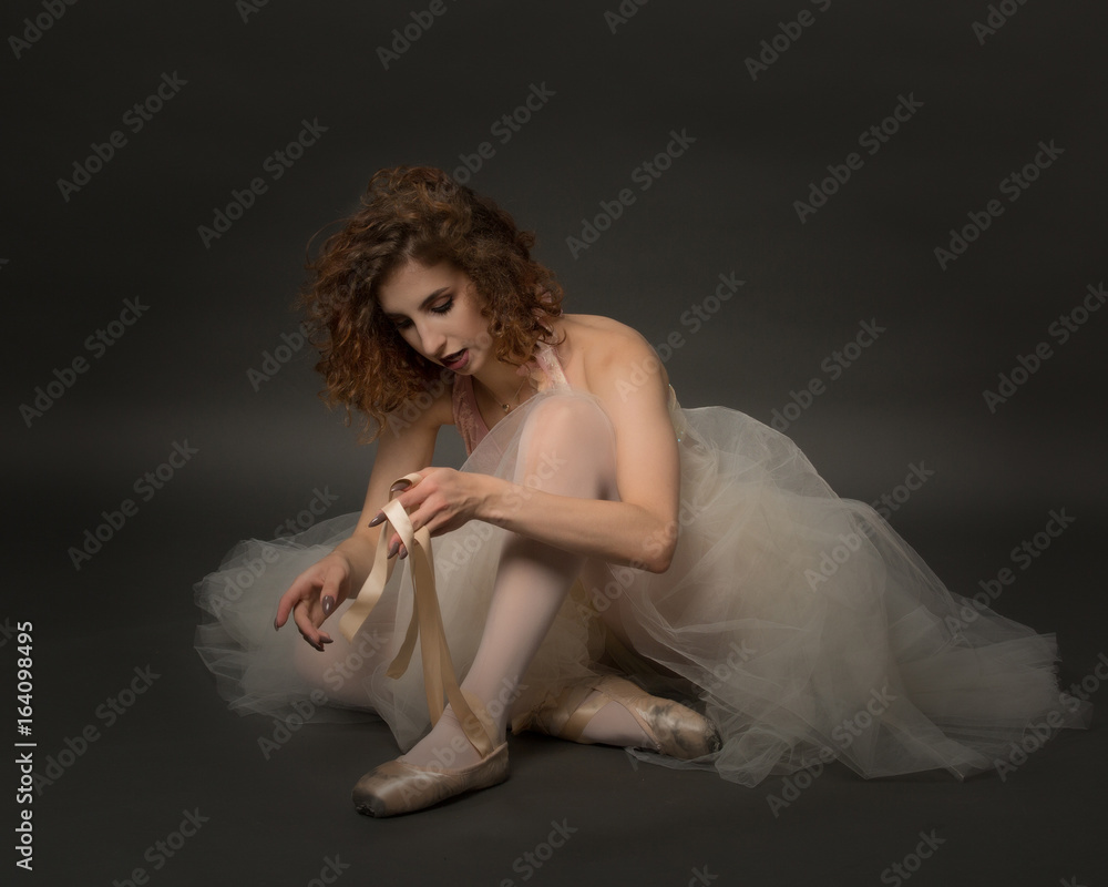 Fototapeta premium Ballerina tying shoes