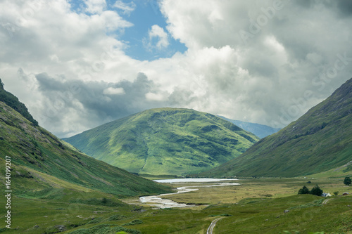 Green mountains and river in cloudy Scotland