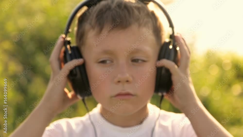 Portrait of a boy in headphones against the sunset Portrait of a boy in headphones against the sunset