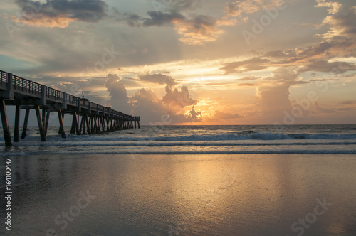 Sunrise over the atlantic ocean with beach and pier © Oliver
