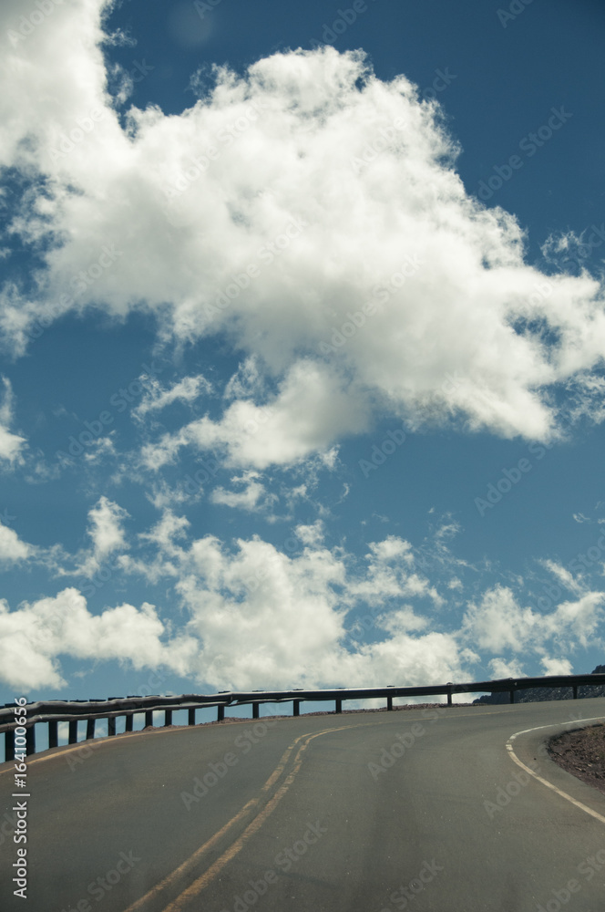 Fototapeta premium Road up mountain into the clouds