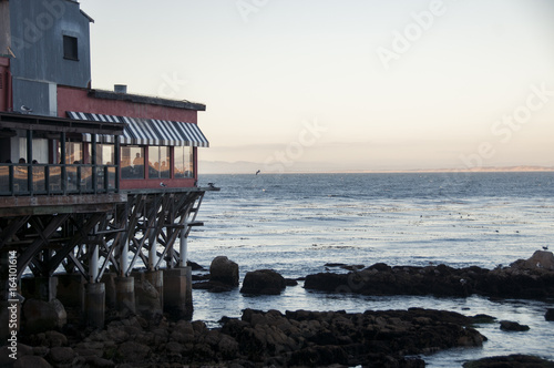 Restaurant on a pier over ocean in Moterrey, California photo