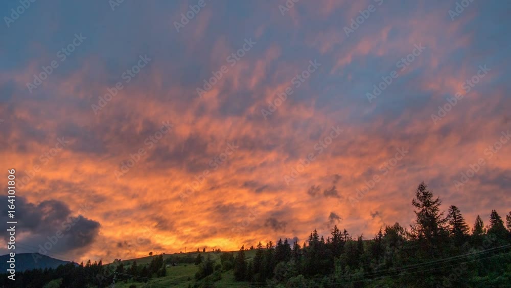 Colorful sunset sky and clouds afterglow. Sun setting above mountains silhouette time lapse. Colorful sunset sky and clouds afterglow. Sun setting above mountains silhouette time lapse.