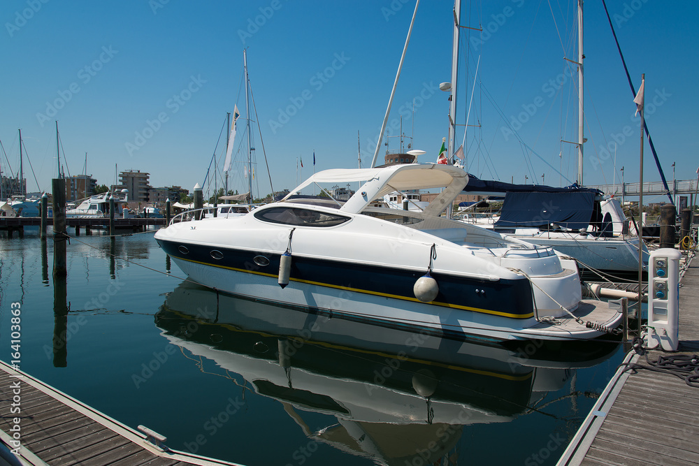 Fototapeta premium White yachts in the port waiting. On the sea is calm.