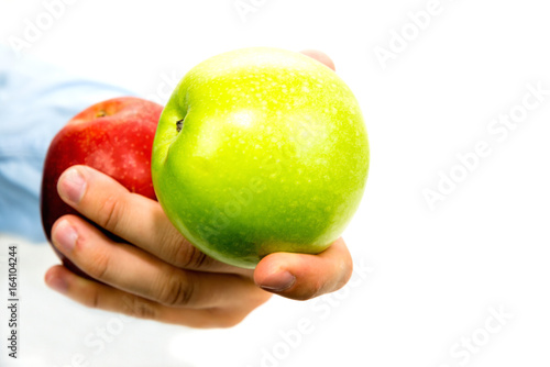 Hand holds green and red apple