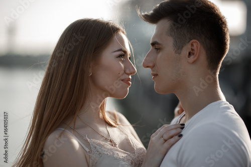 Portrait of young couple in love, enjoying the sunset in city