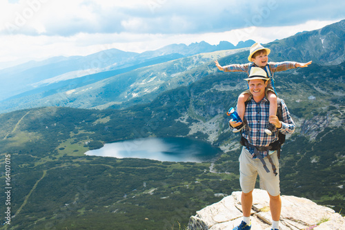 Father and son traveling in Rila mountains Bulgaria