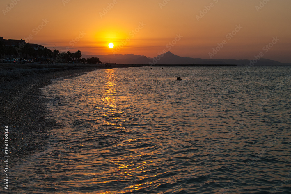 Sunset on the beach of Denia. 