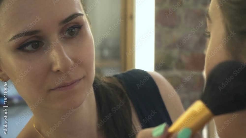 Make-up artist makes a professional make-up for a beautiful girl Make-up artist makes a professional make-up for a beautiful girl
