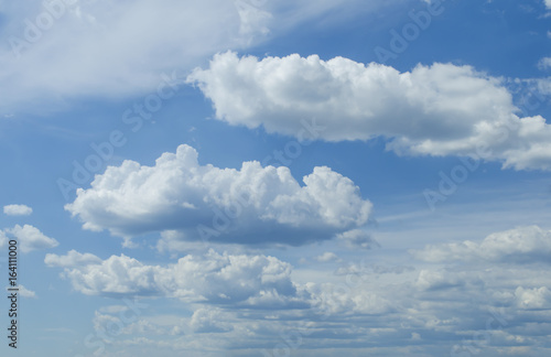 Sunny blue sky background with partial fluffy clouds Photo