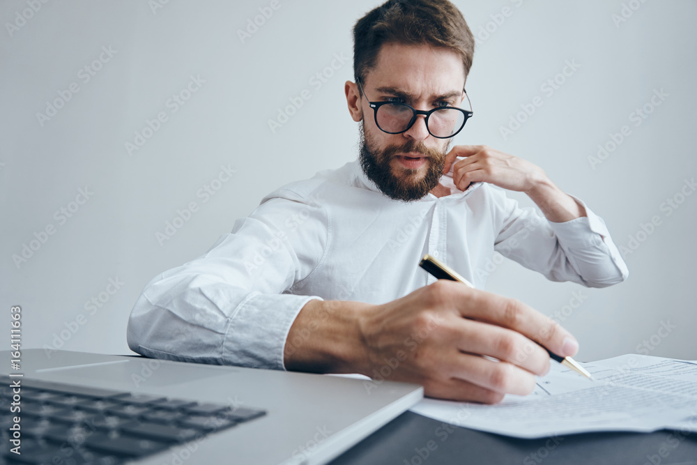 Fototapeta premium Business man with a beard working at his desk in the office
