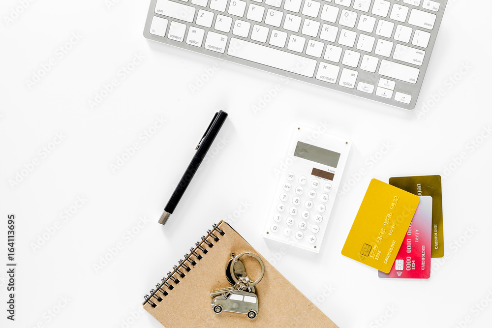 Buying car. Car keys, bank card near keyboard on white background top view copyspace Buying car. Car keys, bank card near keyboard on white background top view copyspace