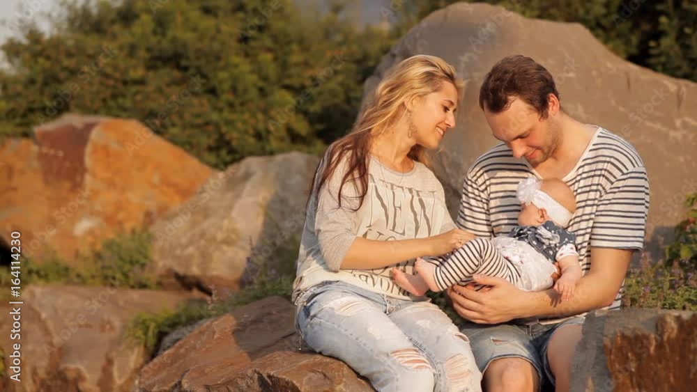 Young parents play with a child in a holiday park Young parents play with a child in a holiday park