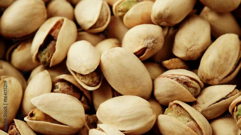 Food background. Roasted pistachio nuts seed with shell close up. Dieting concept. Dolly slider shot 4K ProRes HQ codec Food background. Roasted pistachio nuts seed with shell close up. Dieting concept. Dolly slider shot 4K ProRes HQ codec