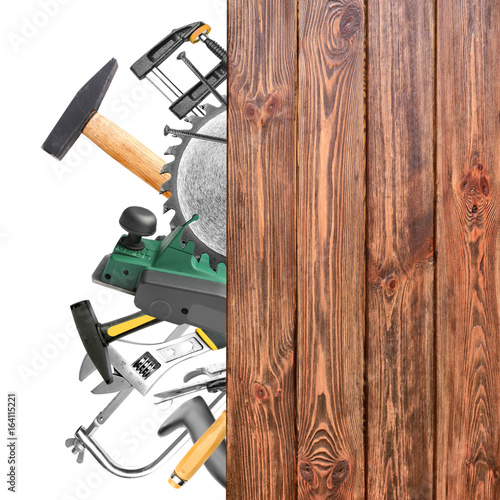 Set of carpenter's tools and wooden board on white background