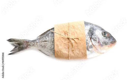 Canvas Print Fresh dorado fish wrapped in paper on white background