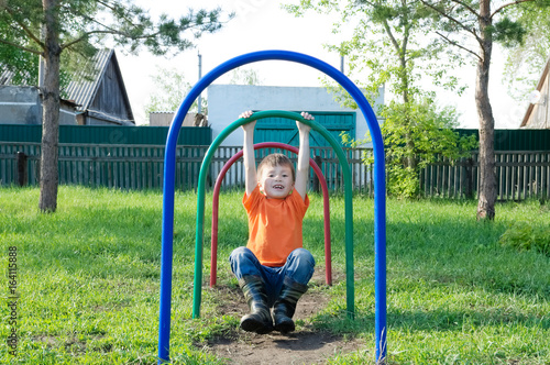 Kid playing outdoors. Boy on playground, children activity. Active healthy childhood concept