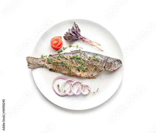 Plate with tasty fried fish on white background