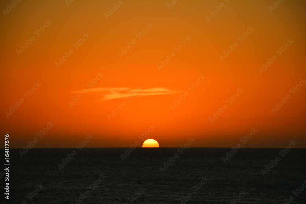 Orange sunset behind sea