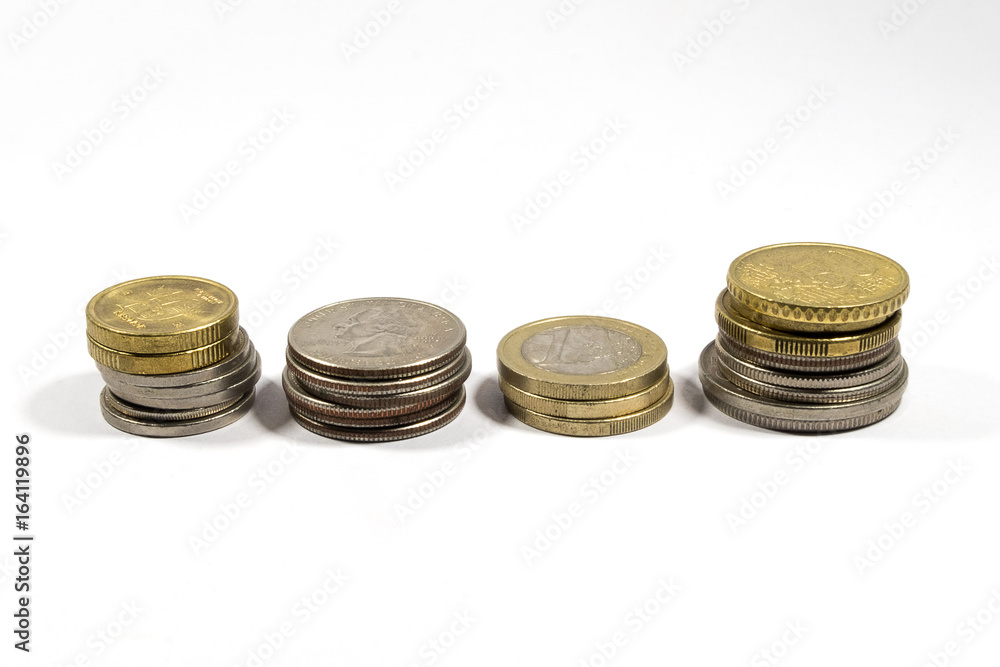 Many coins from different countries in columns on white background Many coins from different countries in columns on white background